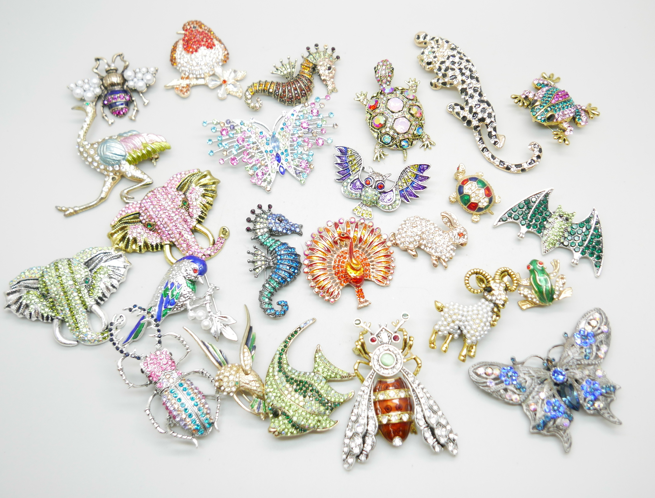 A collection of twenty-three rhinestones animal, bird, insect and other brooches, and one