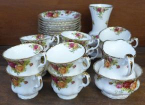 Royal Albert Old Country Roses china, ten cups, saucers and tea plates, cream and sugar and vase