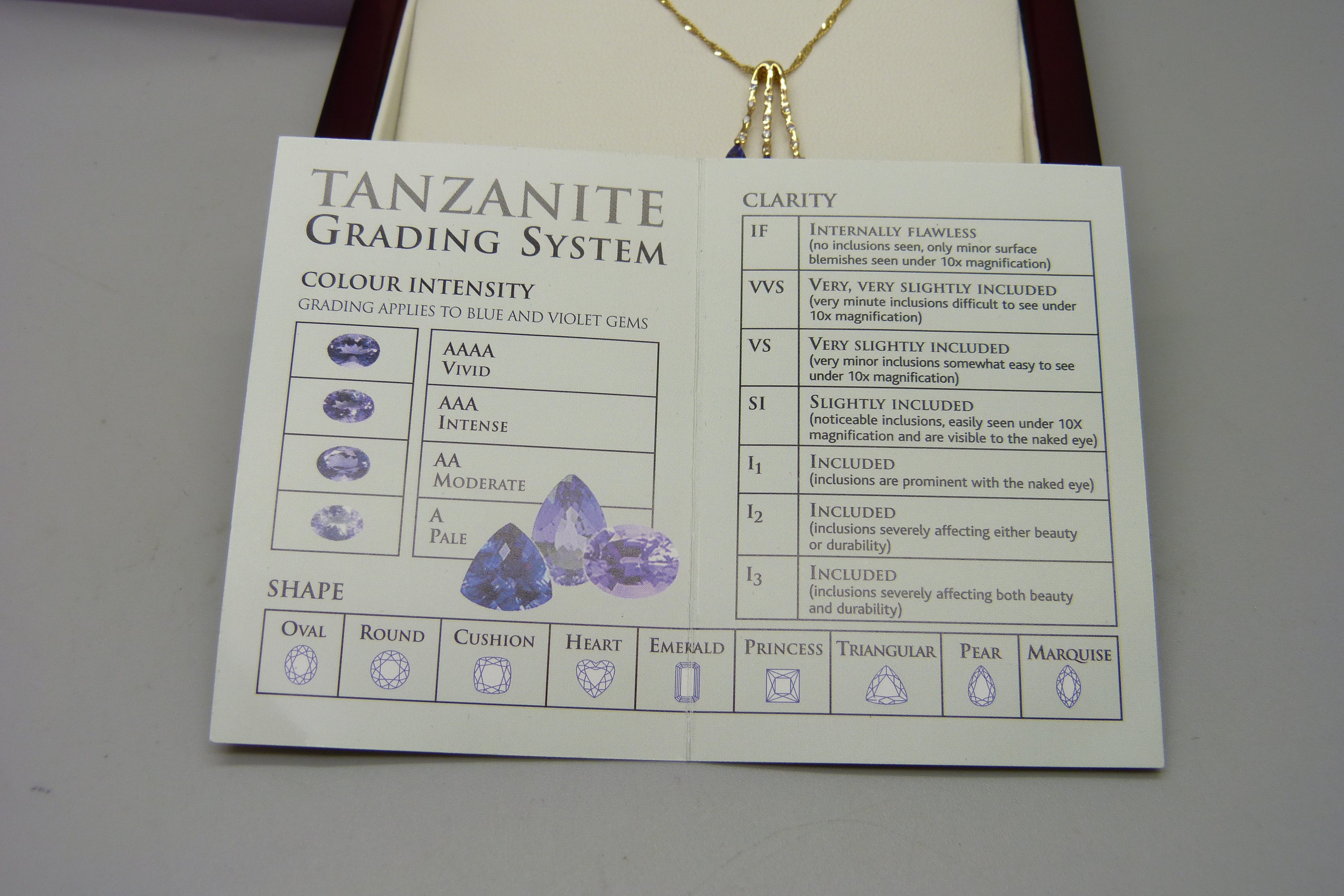 An 18ct yellow gold pendant set with small diamonds and three pear shape grade AAA tanzanite stones, - Image 6 of 6