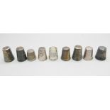 Eight silver thimbles and one other thimble