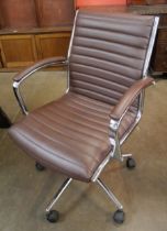 An Eames style chrome and brown leather revolving desk chair