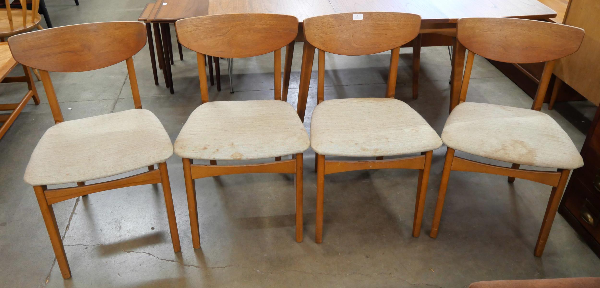 A set of four teak dining chairs