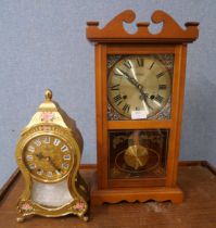 A Highlands chiming wall clock and an Eluxa gold and floral clock with wall bracket