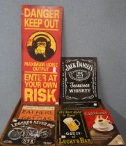 Assorted tin advertising signs