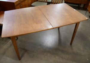 A teak extending dining table