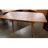 A teak extending dining table