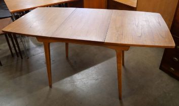 A teak extending dining table