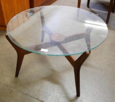 A teak and glass topped circular coffee table