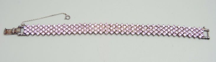 A silver and pink stone bracelet
