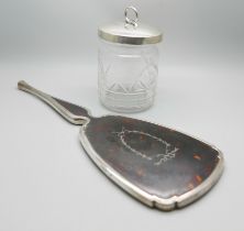 A silver and tortoiseshell hand mirror and a silver topped glass preserve jar, lid 37g