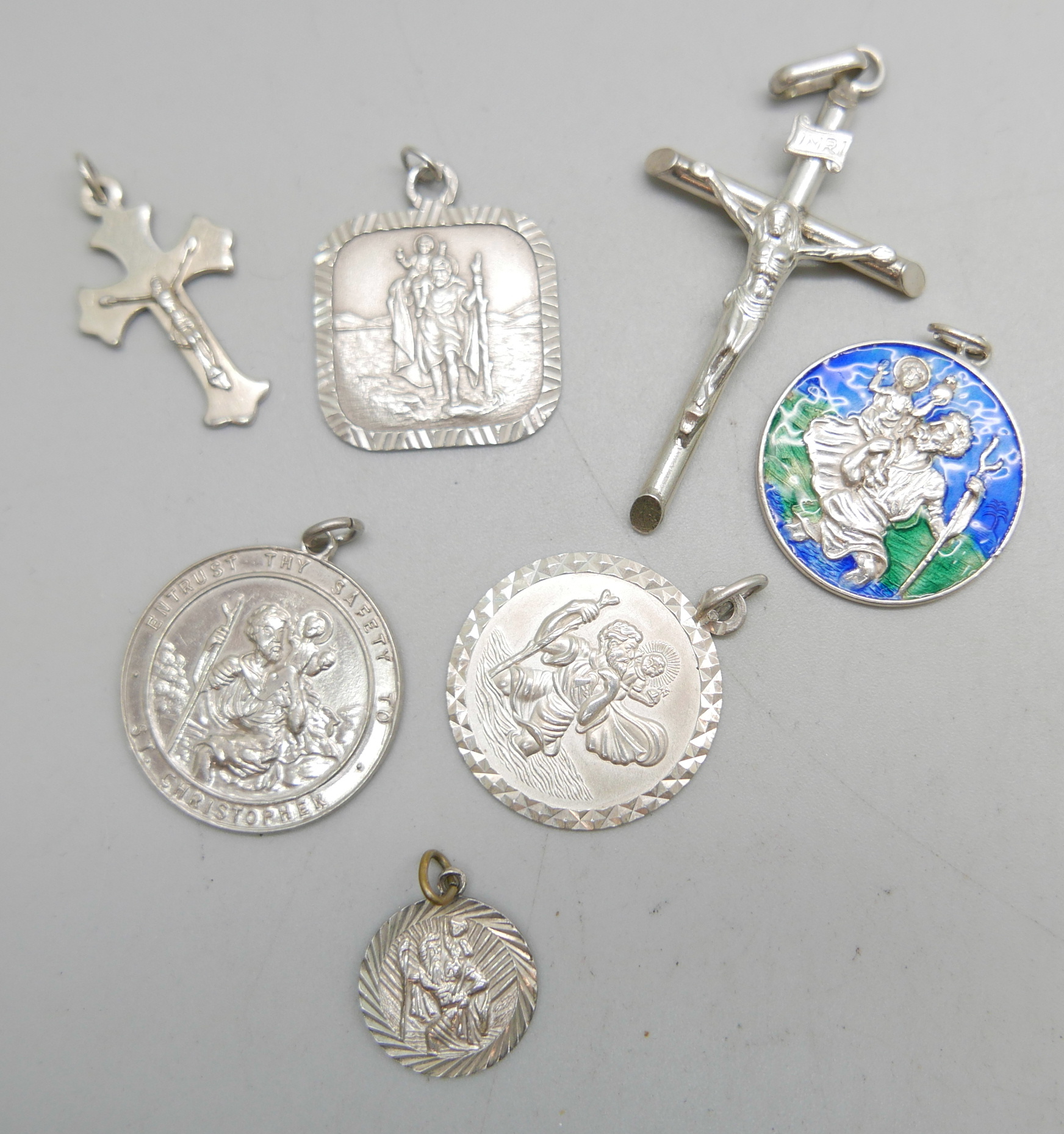 Five silver St. Christopher pendants and two silver crucifix pendants, 25g