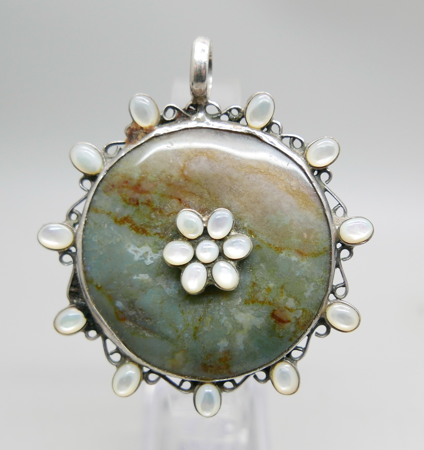 A large silver, stone and mother of pearl pendant, 6cm