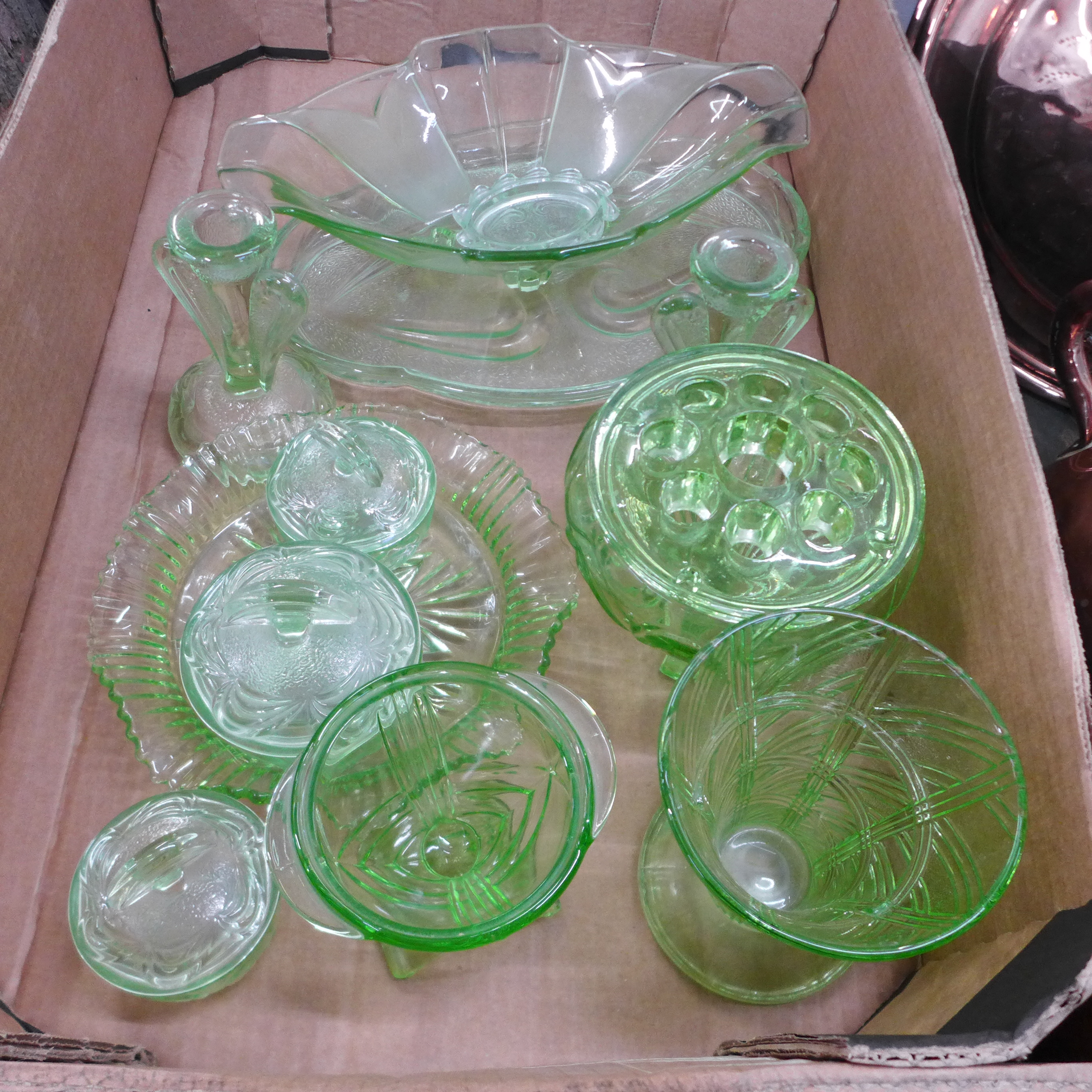 A collection of green glass including a flower frog, dressing table set, vases, etc. (two