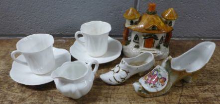A pastille burner, two Shelley white cups, saucers and cream jug and two china shoes **PLEASE NOTE