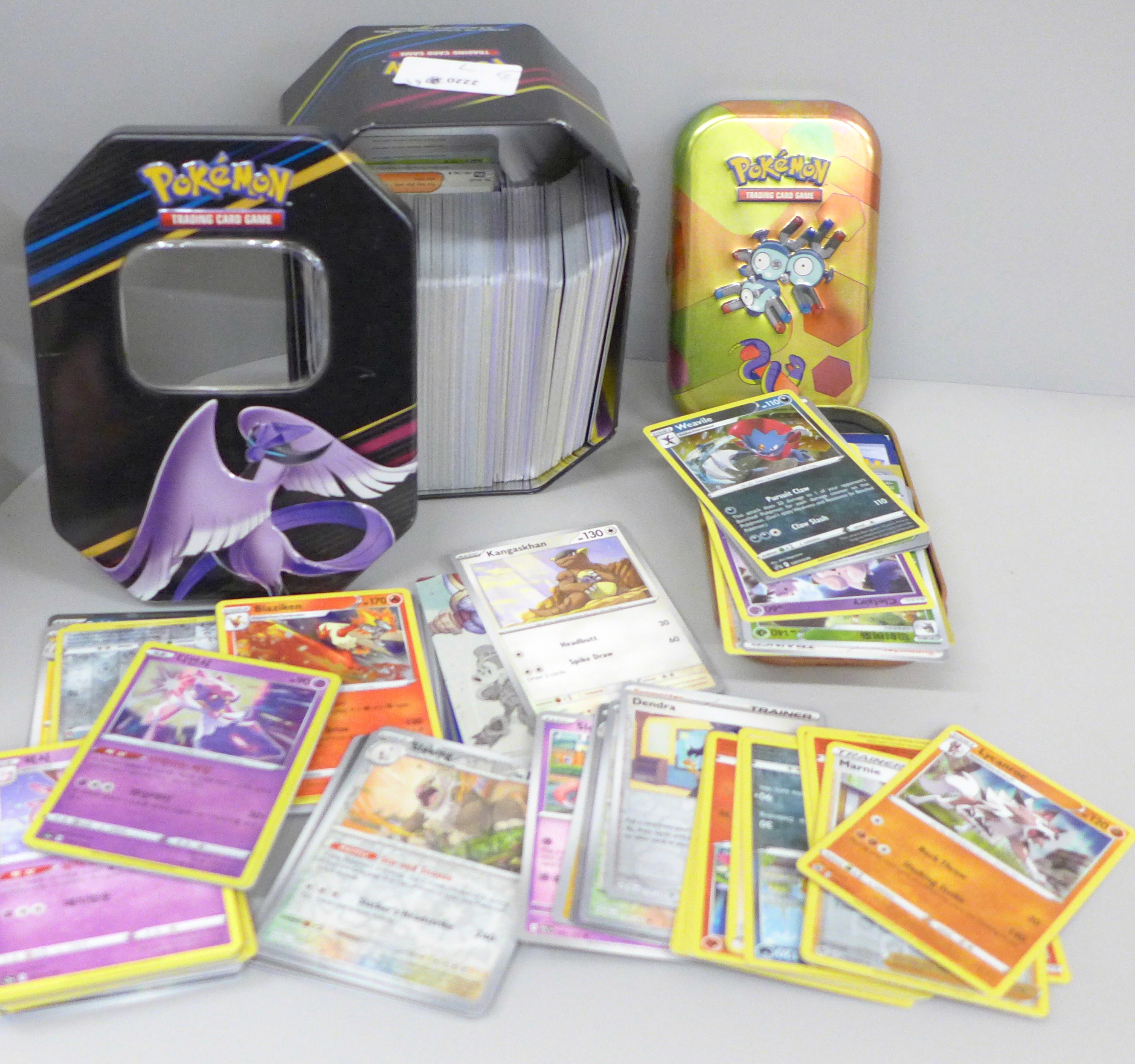 Two tins of Pokemon cards