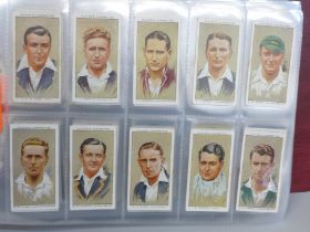 Cigarette cards; an album containing ten sets of Players cigarette cards, including cricketers, 1934