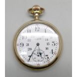 A gold plated Elgin pocket watch with railroad dial, screw back case