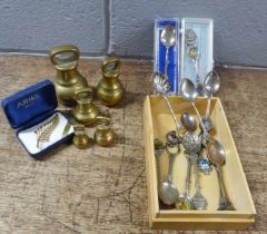 A collection of collectors spoons and a set of brass weights plus a gold plated brooch **PLEASE NOTE