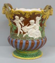 A 19th Century majolica jardinière with ram's head detail and embossed with classical Roman