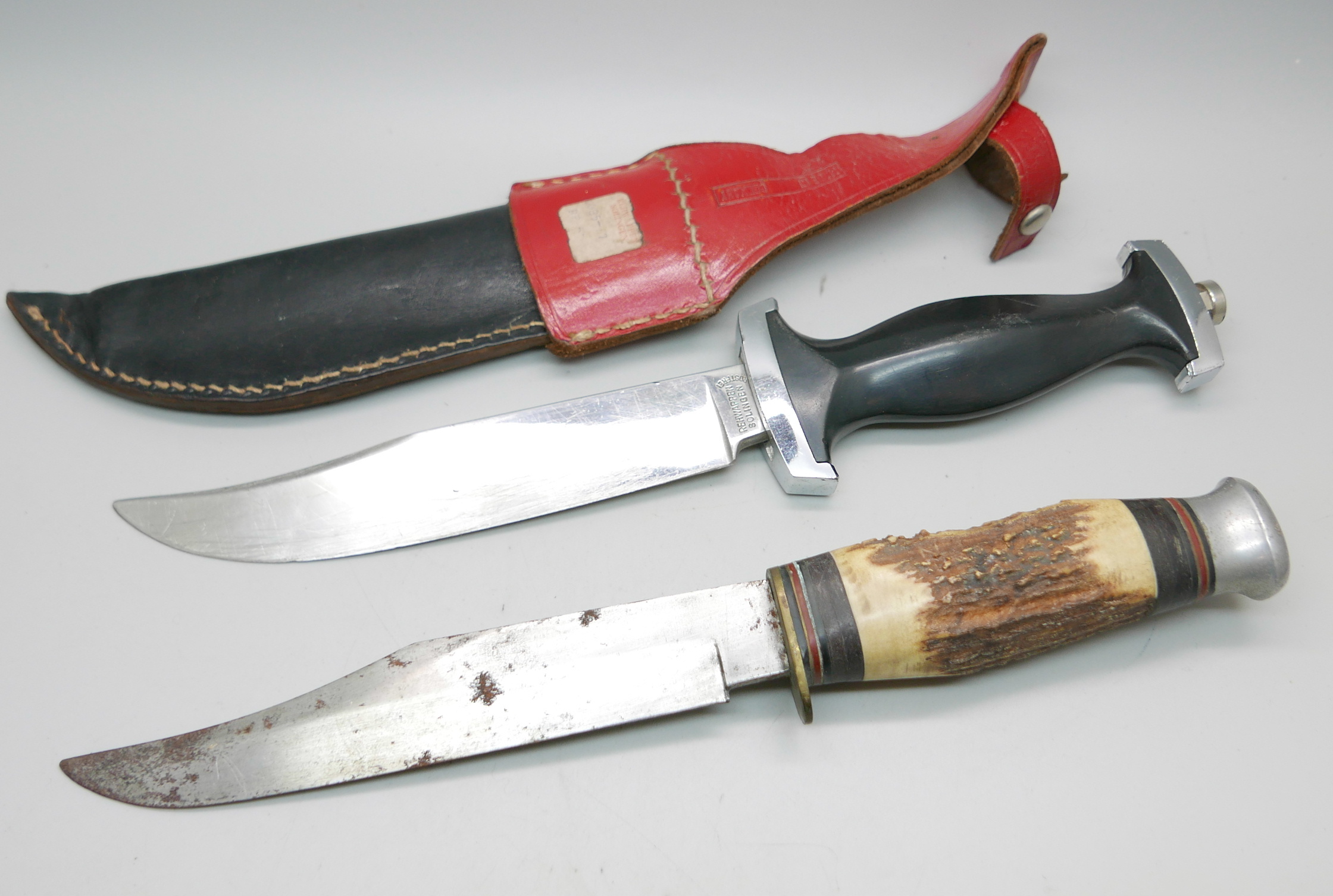 A dagger with scabbard, the blade marked Rehwappen Solingen, and one other dagger wtih antler