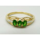 A silver gilt, diopside three stone ring, S