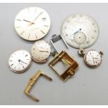 Four Omega strap buckles, an International Watch Company watch dial, three lady's Omega watch