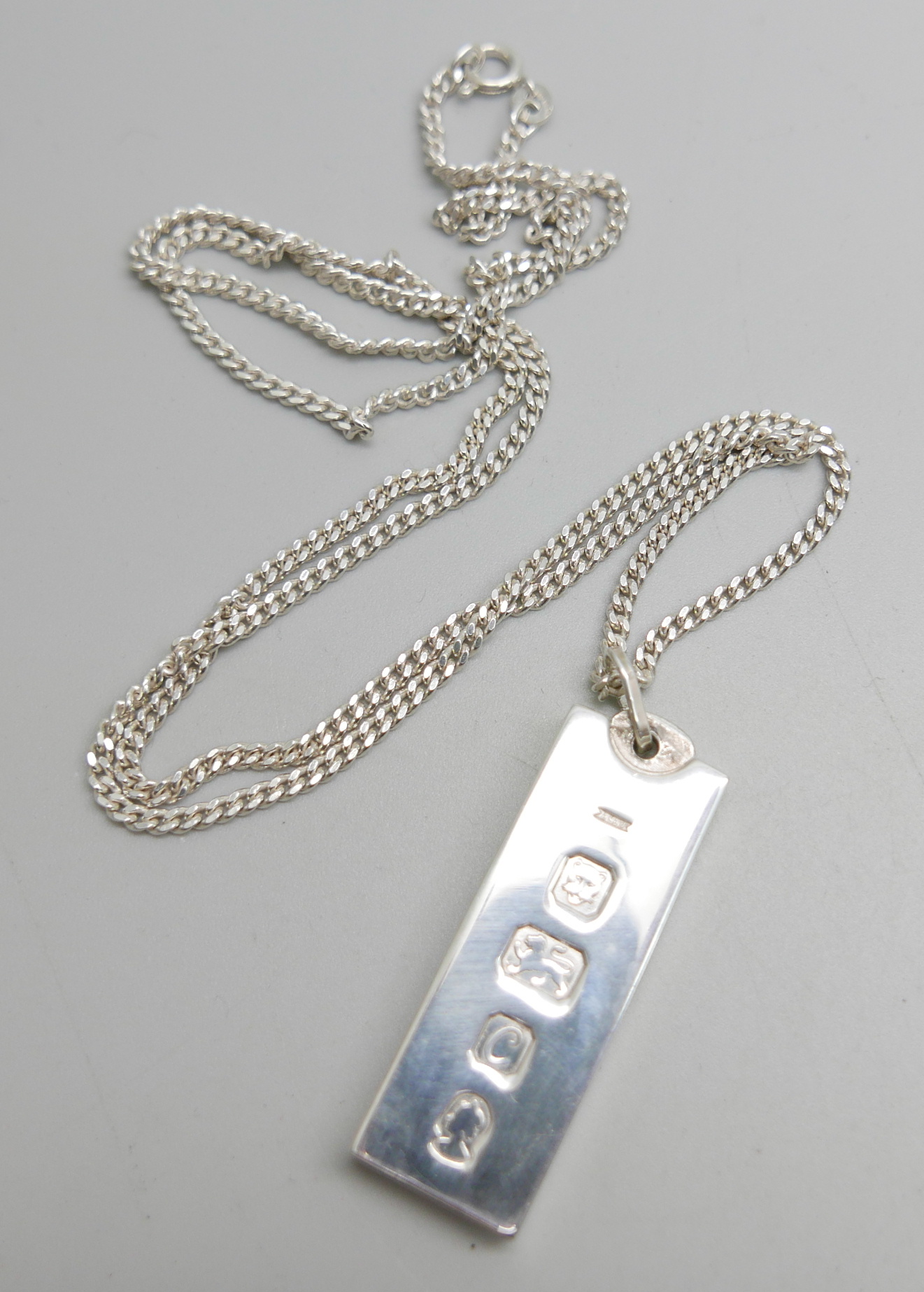 A silver ingot pendant and chain, 45g, chain 68cm