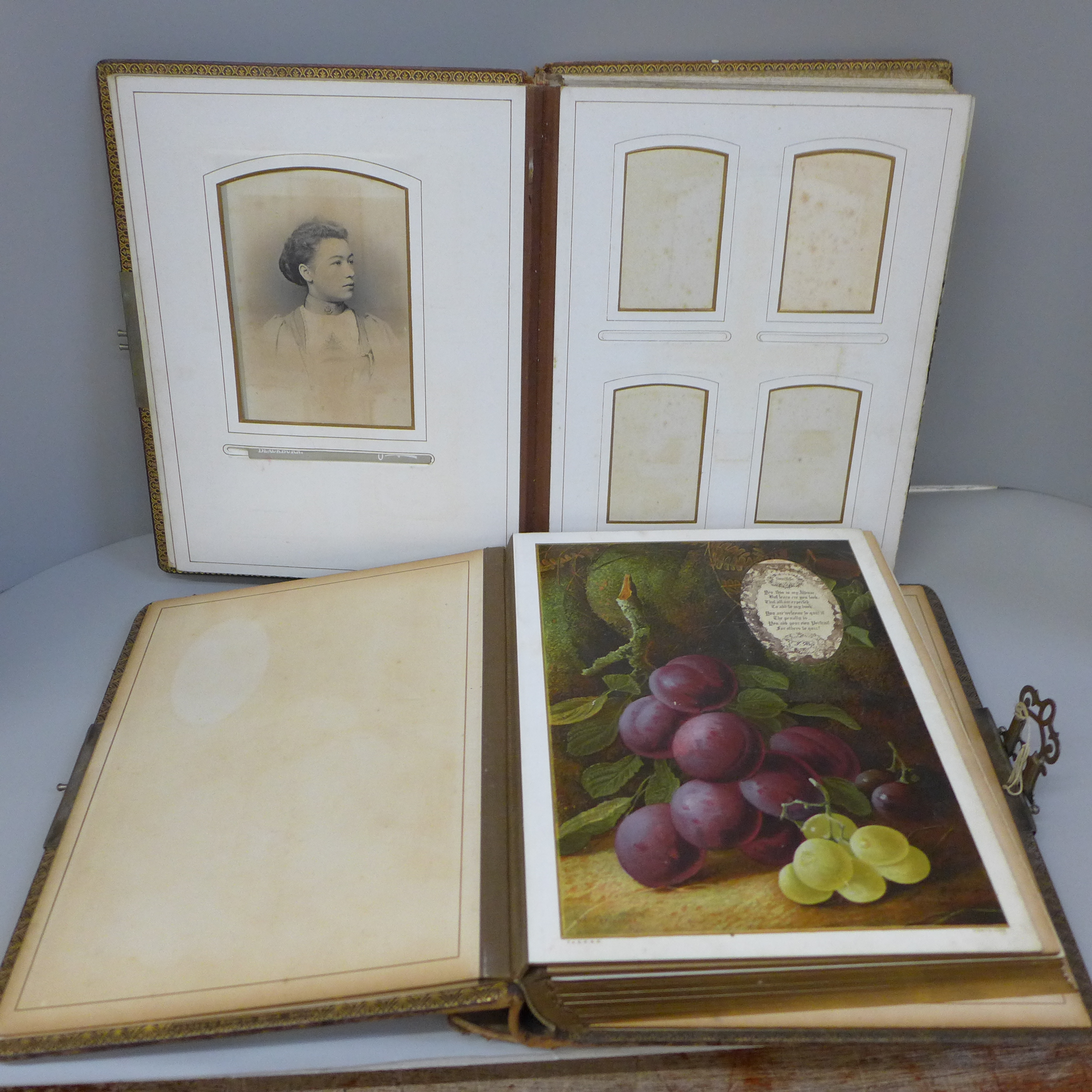 Two Victorian photograph albums with coloured mounts, some cabinet cards and CDVs