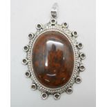 A large hallmarked silver and stone set pendant, London import mark for 1977, 48mm wide