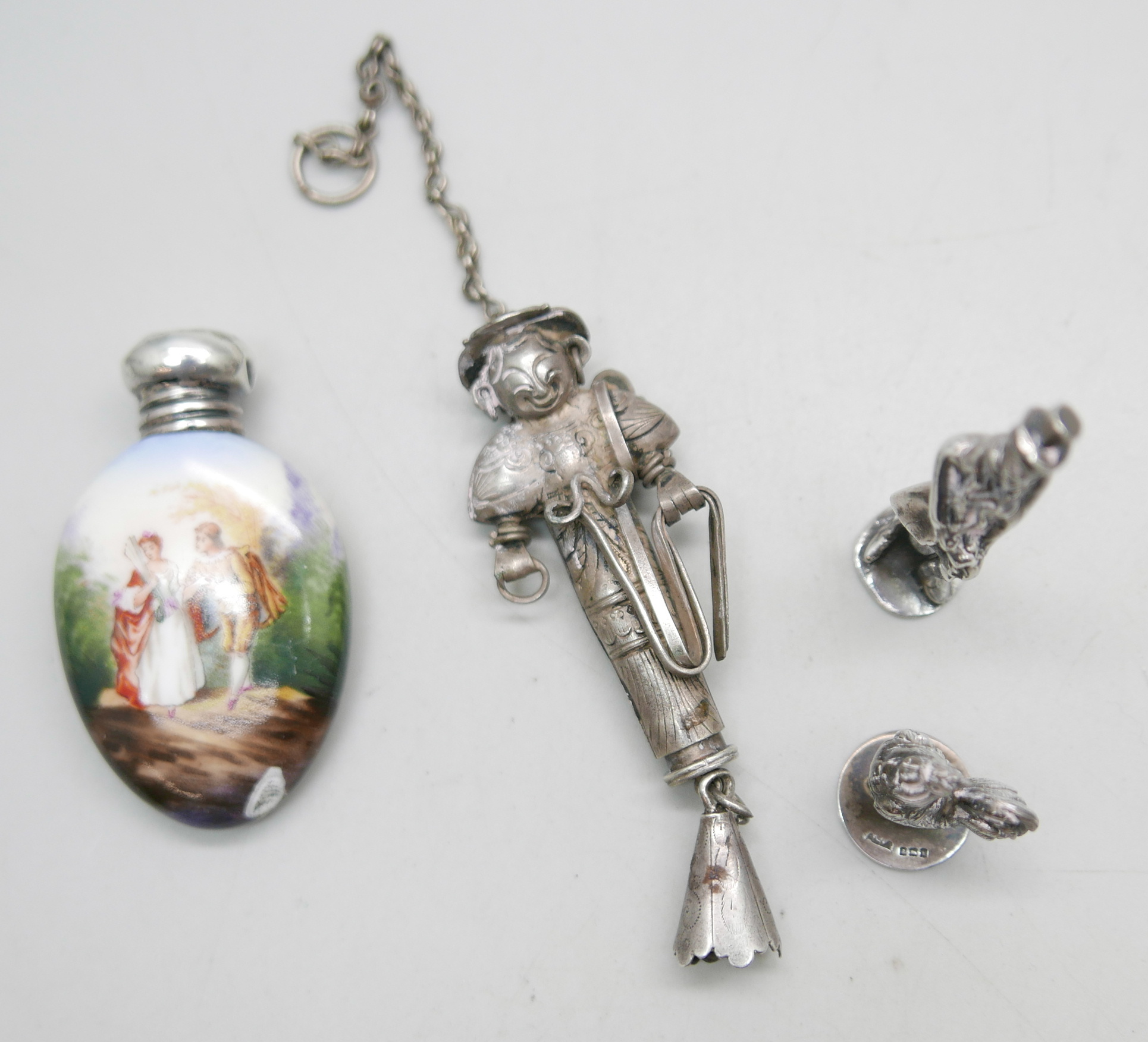 An enamel and silver topped scent bottle, a/f, two hallmarked silver models, a gentleman and a
