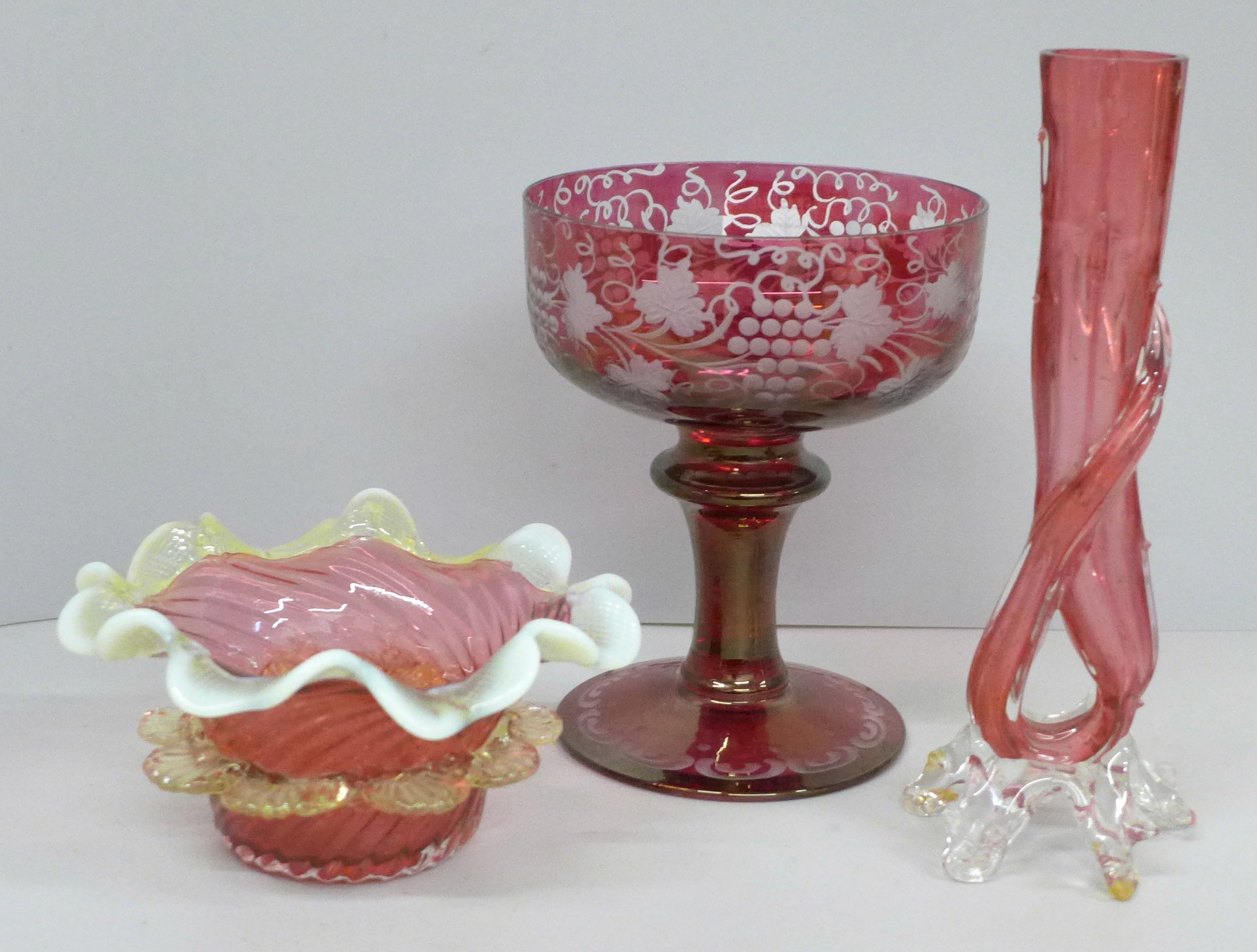 A cranberry and white Kralik Thorn vase, a ruffle edge cranberry glass bowl and a cranberry cut