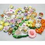 A collection of floral themed jewellery, a pink enameled flower brooch, five celluloid pieces, three