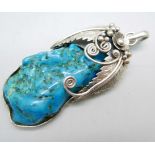 A large silver and turquoise pendant and chain, length 7cm