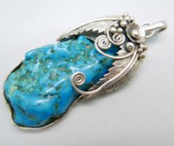 A large silver and turquoise pendant and chain, length 7cm