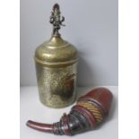 A chase engraved brass Indian lidded caddy with Ganesha top detail, 33cm and a leather powder case