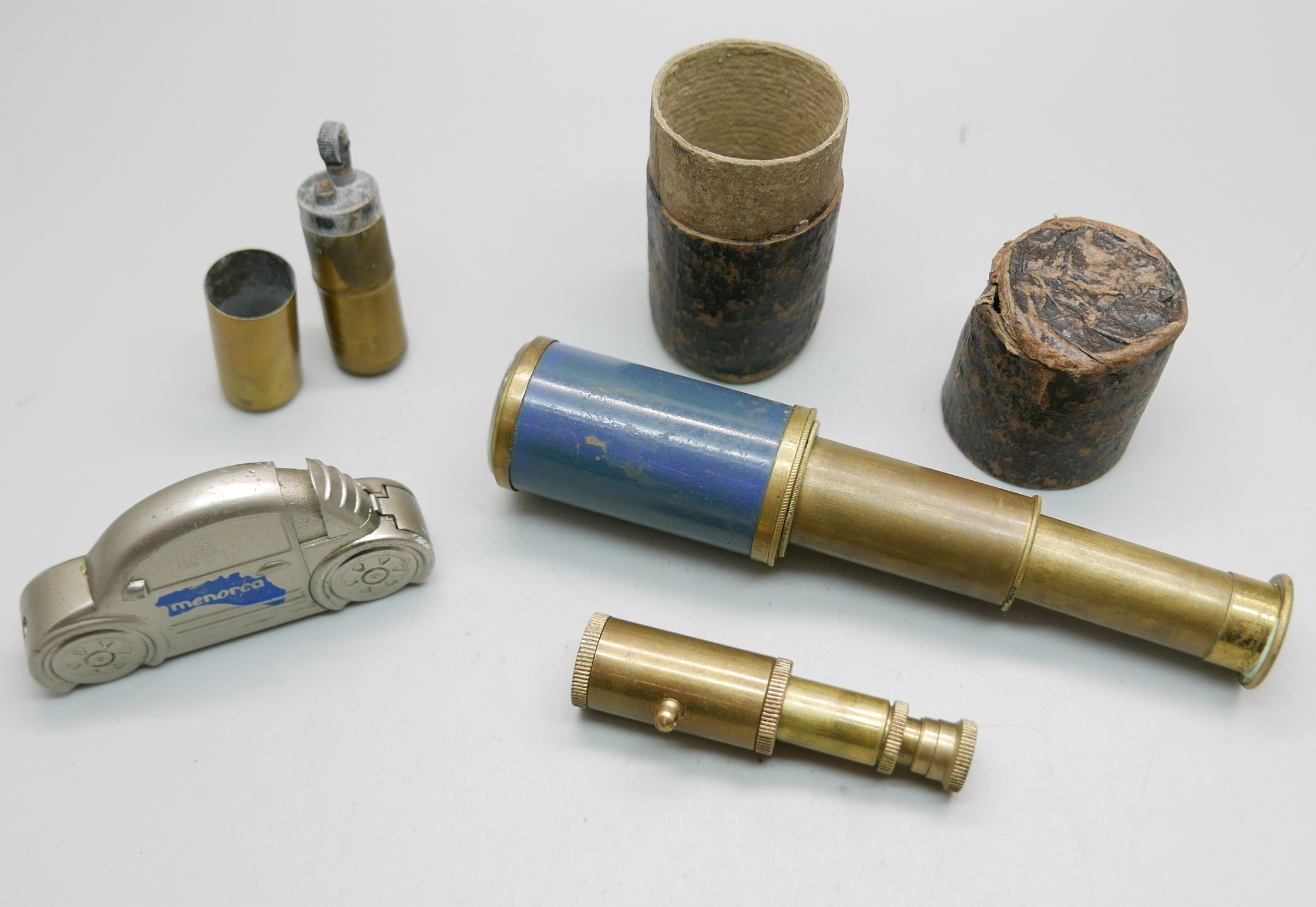 A brass trench art type lighter, a pocket telescope, with case, and one other small telescope and