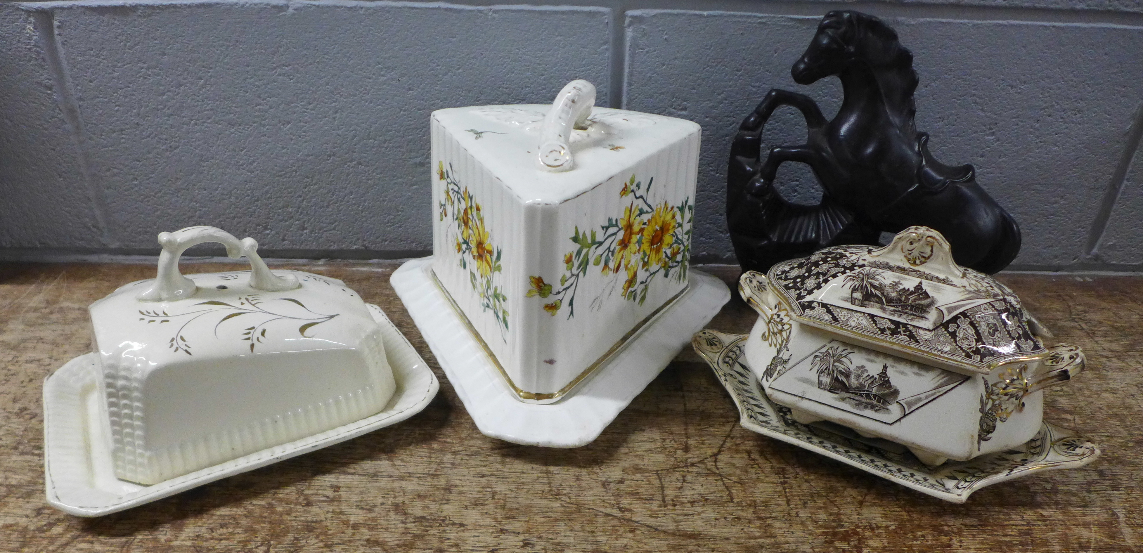 A 19th Century German porcelain cheese dish and cover, a sauce boat and cover on stand with
