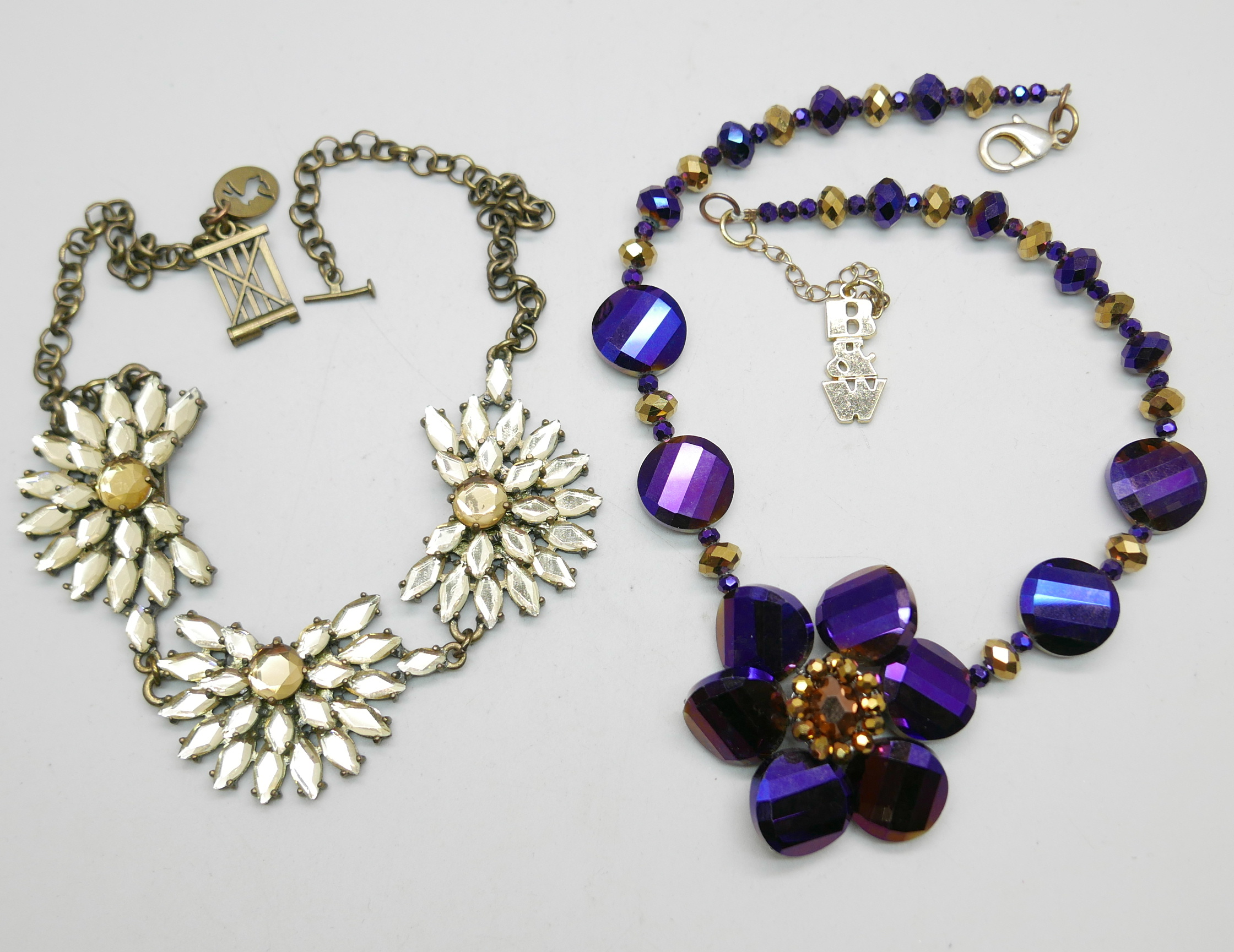 A Butler and Wilson Purple and Gold necklace and a Joules rhinestone three flower necklace