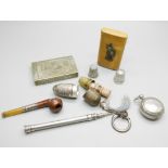 A propelling pencil, tests as silver, a silver mounted miniature pipe, two silver thimbles (one