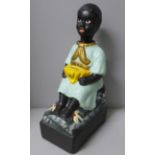 A French charity money box in the form of a seated child with rocking head