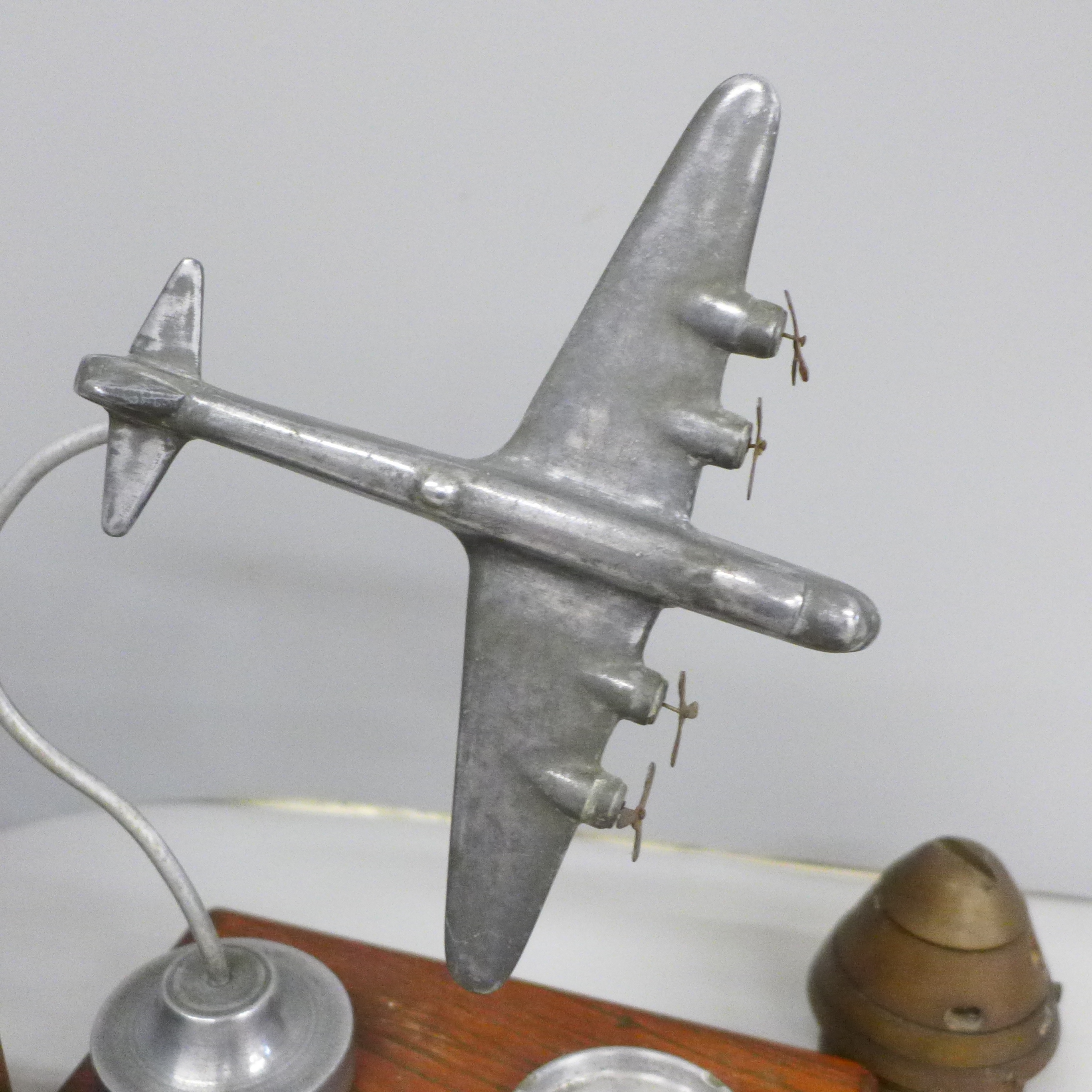 An ash tray with bomber plane decoration, a lamp and an ammunition nose cone - Image 4 of 5