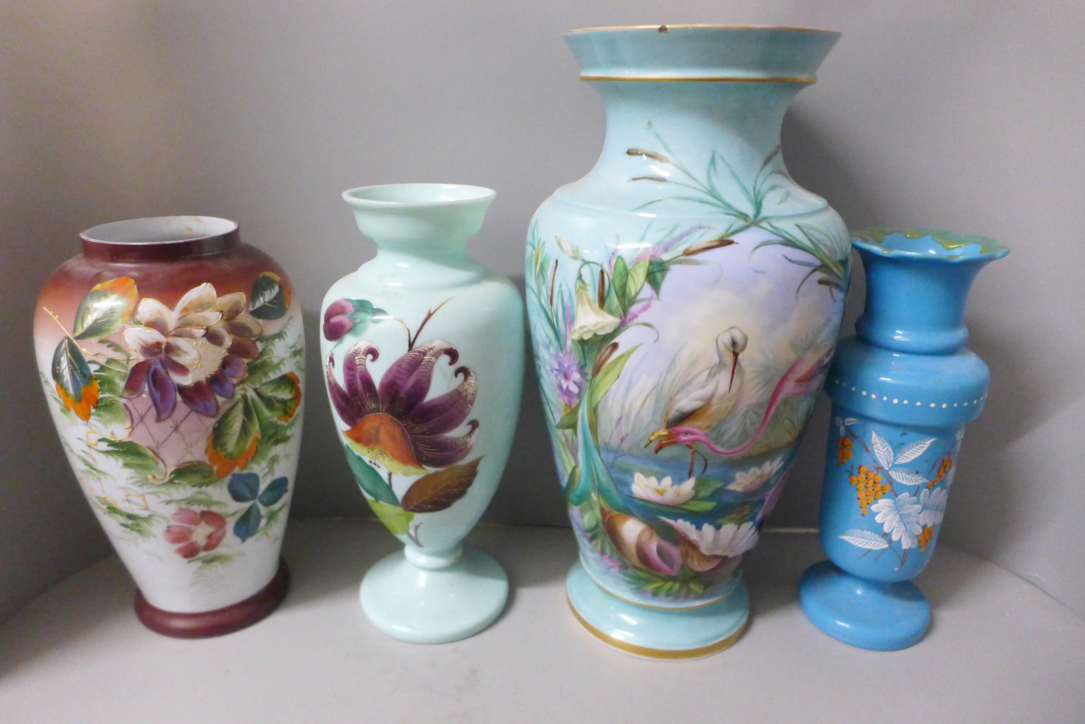 Three hand painted opaline glass vases and one large 19th Century blue glass vase decorated with