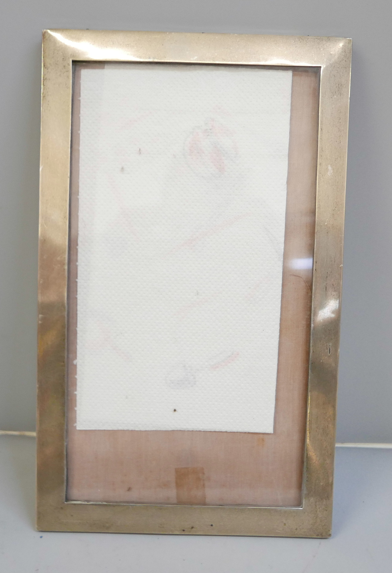A silver photograph frame, 19cm x 33cm, lacking back stand