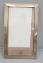 A silver photograph frame, 19cm x 33cm, lacking back stand