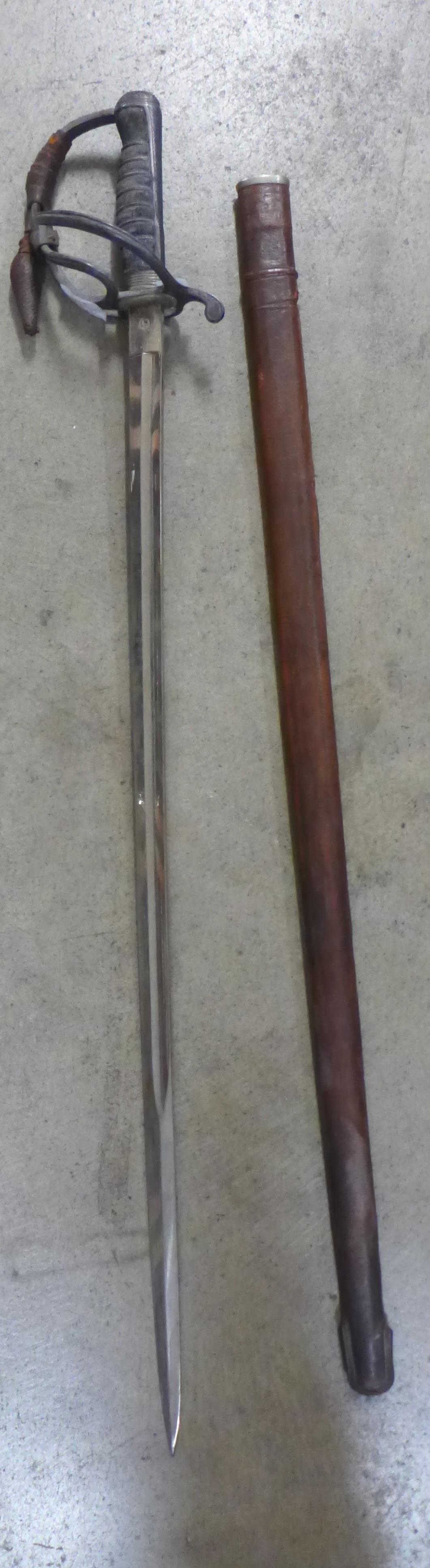 A George V officers sword, with shagreen handle and leather scabbard, the blade marked Woolwich,