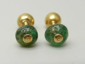 A pair of yellow metal and emerald earrings, with screw fitting