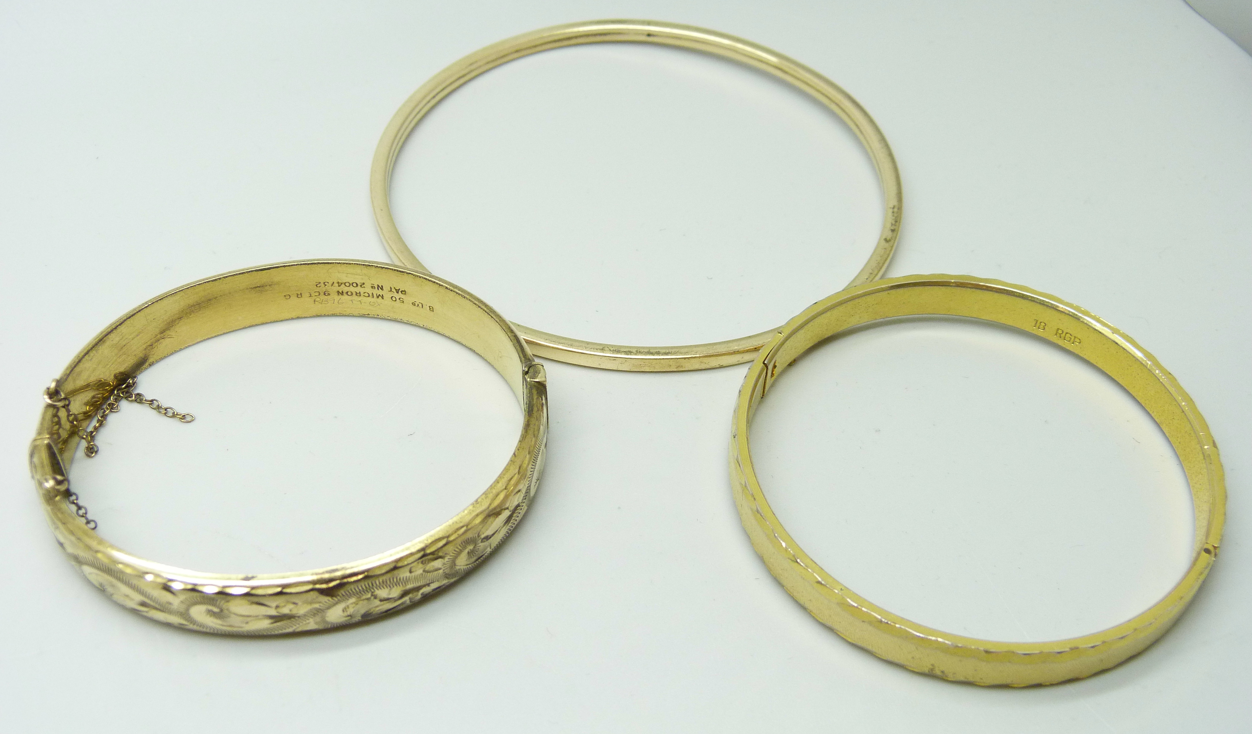 Three vintage rolled gold bangles