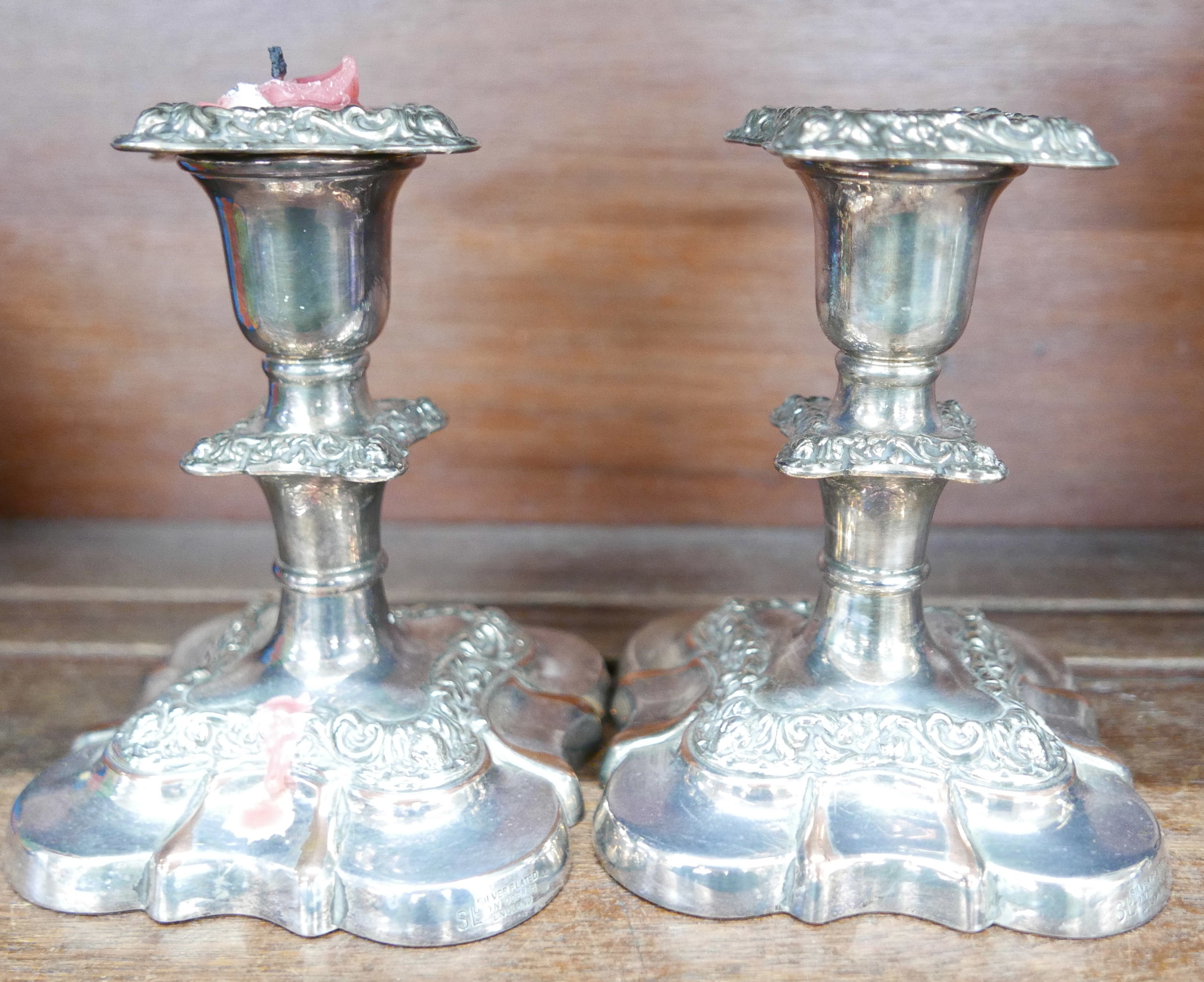 A silver plate coffee pot on stand, on paw feet and crest plate and a pair of plated candlesticks - Image 2 of 4