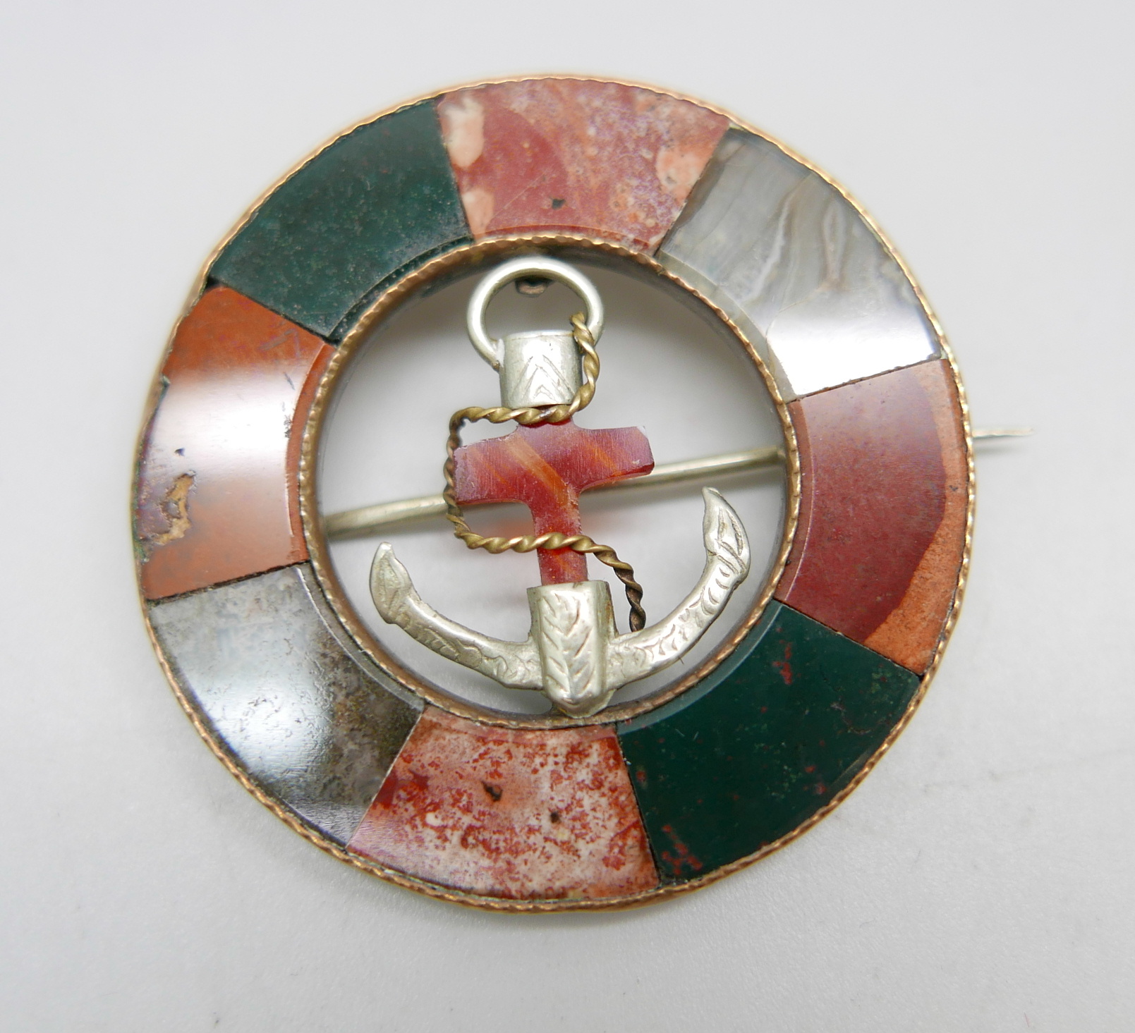 A circular agate set brooch with anchor detail, 46mm