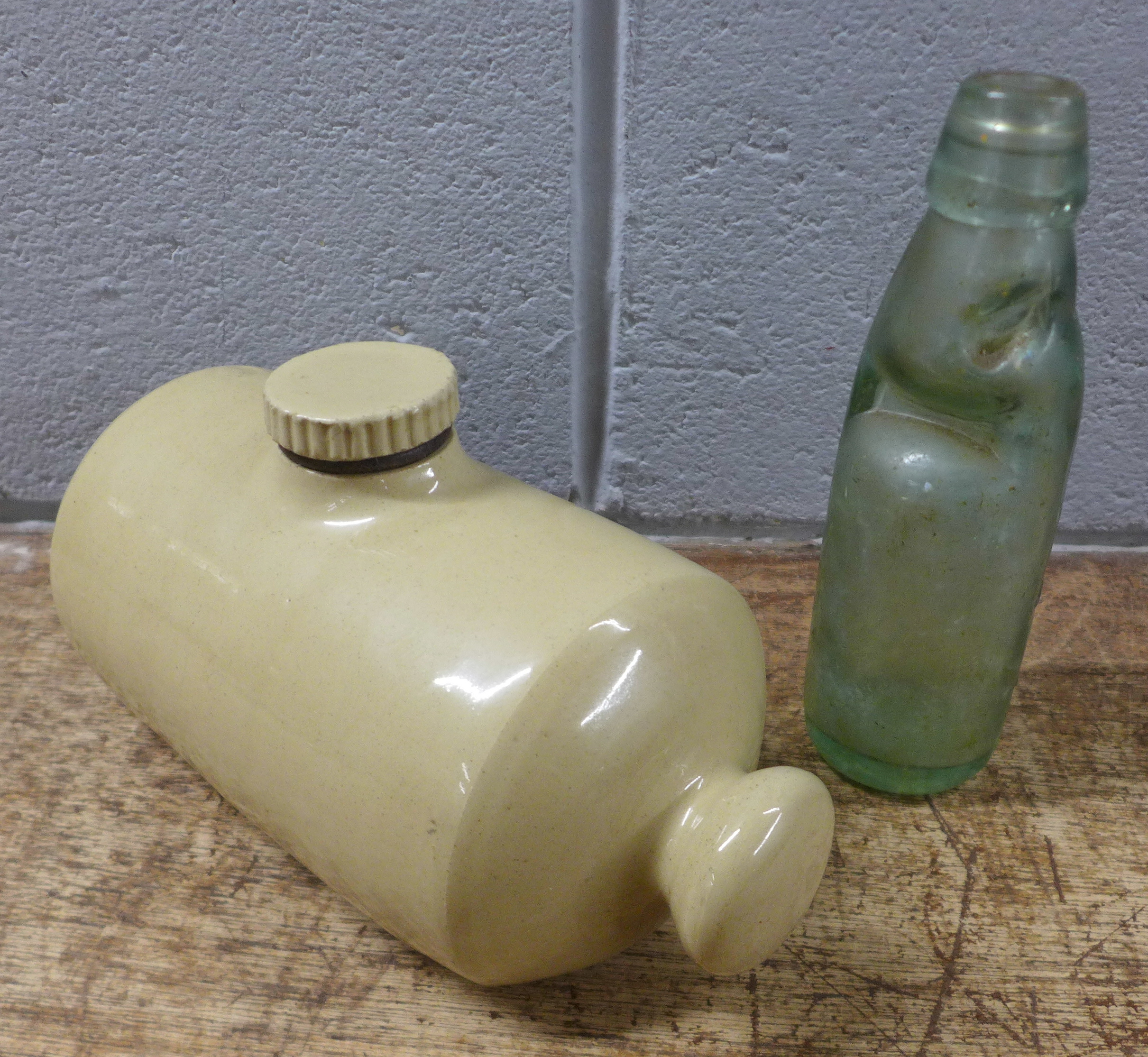 A glass cod bottle, J.J. Mettham, Mansfield and a hot water bottle